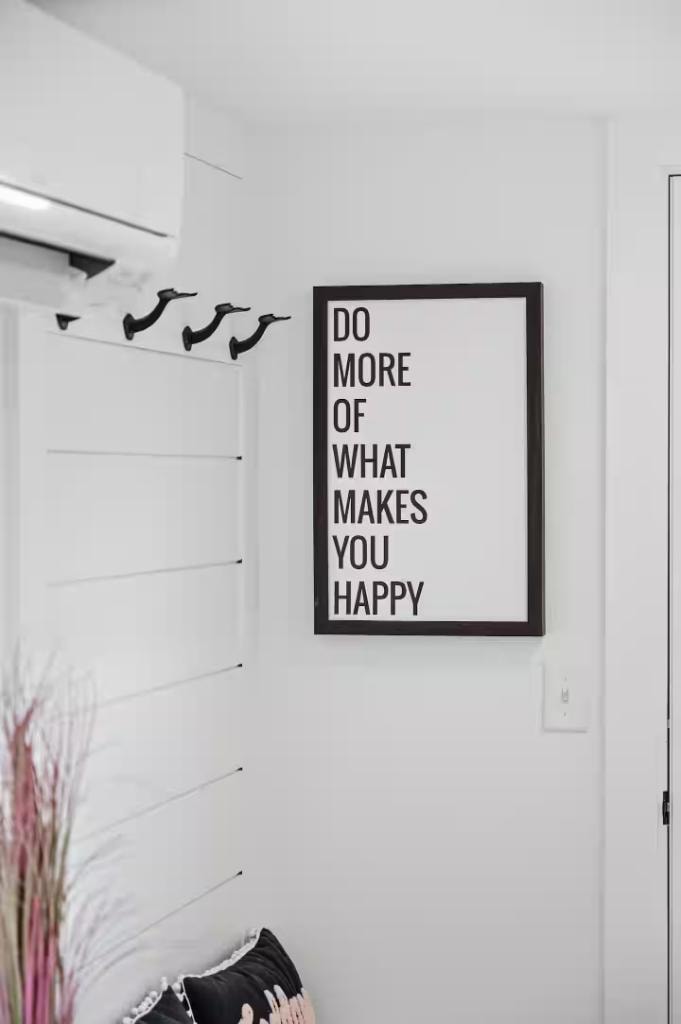Cape Coddage entryway — "Do More of What Makes You Happy" framed print with coat hooks and mini-split